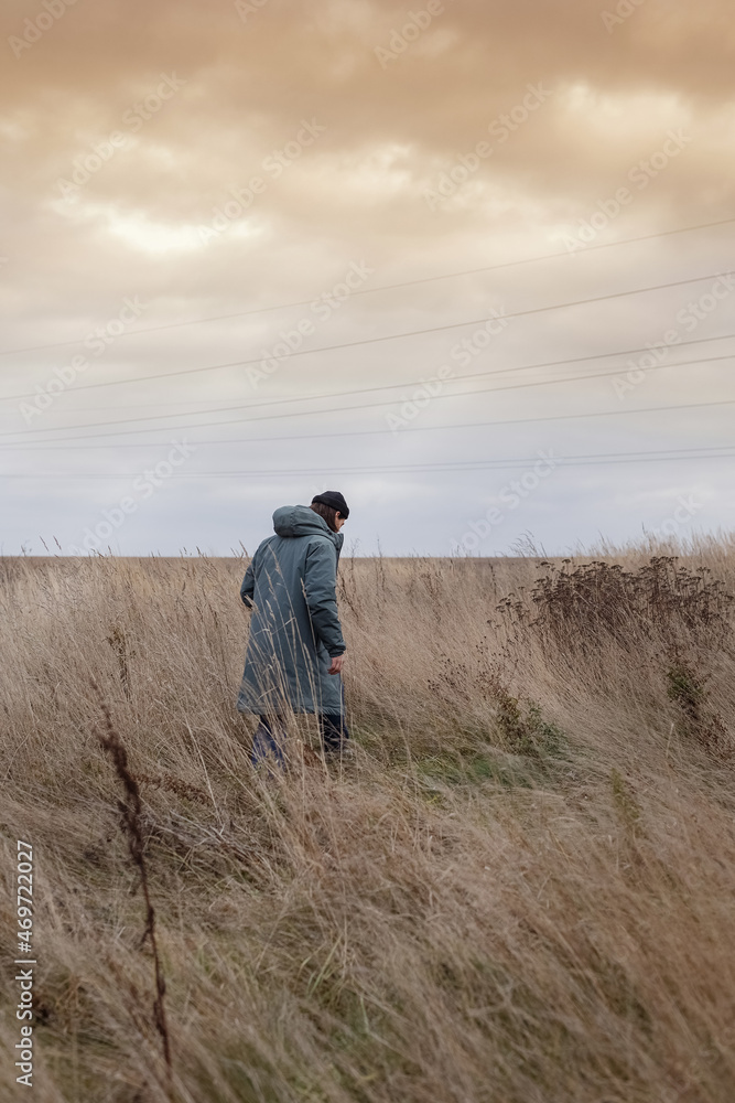 A man walks across the field. Photo A man walks across the field. Photo