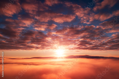 Morning shot of rising sun over the fog. Beautiful dream-like shot in the sky © Vitalii