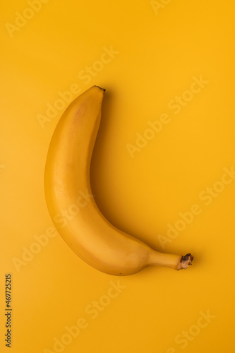Yellow banana on a yellow background.