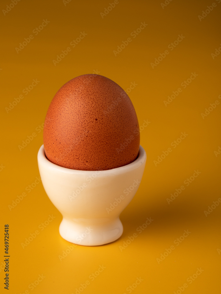 Egg on a stand on yellow background. Egg on a stand on yellow background.