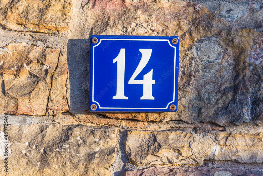 house number forteen made of enamel at an old house wall house number forteen made of enamel at an old house wall
