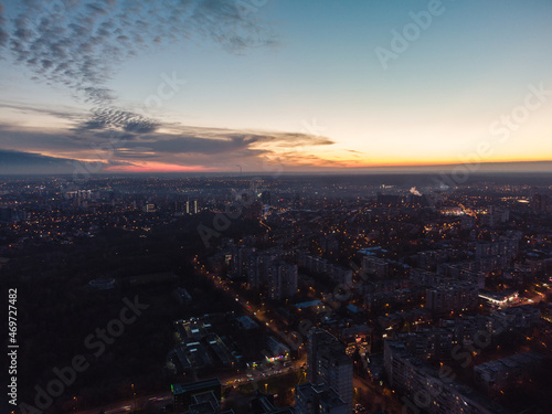 Aerial view Kharkiv city center, Pavlove pole with night lights on streets of residential district, scenic sunset view with epic skyscape