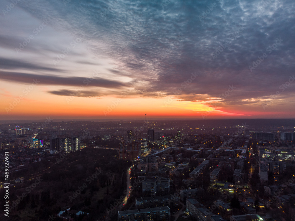 Aerial vivid colorful sunset panoramic view with epic skyscape. Kharkiv city center, Pavlove pole, botanical garden. Residential district streets and buildings in evening light