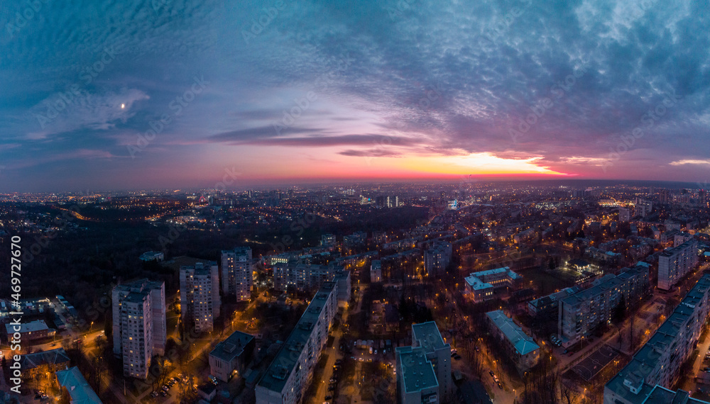 Obraz premium Aerial sunset scenic panorama on Kharkiv city, Pavlove pole. Night lights on streets of residential district and scenic cloudy colorful sky after sunset
