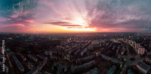 Aerial scenic vivid colorful sunset panorama wide view with epic skyscape. Kharkiv city center, Pavlove pole residential district streets and buildings in evening light photo