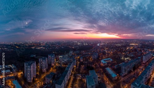 Aerial sunset scenic panorama on Kharkiv city, Pavlove pole. Night lights on streets of residential district and scenic cloudy colorful sky after sunset