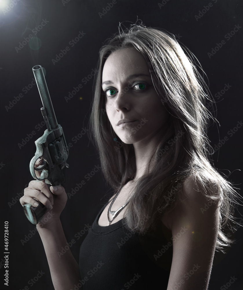 young woman in undershirt with revolver, at nigth. crying girl with big green eyes young woman in undershirt with revolver, at nigth. crying girl with big green eyes