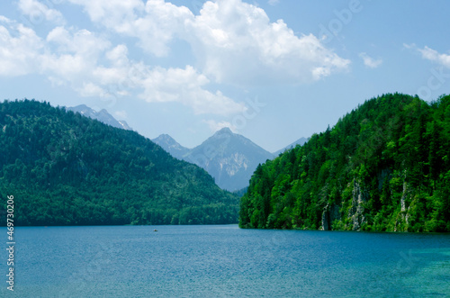 Alpsee lake landscape with Alps mountains near Munich in Bavaria, Germany. Crystal clear mountain lake and rocky mountains © Tamara