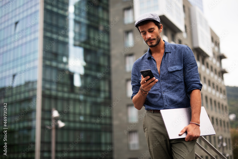 Young stylish man using the phone outdoors. Fashion happy guy enjoy outdoors... Young stylish man using the phone outdoors. Fashion happy guy enjoy outdoors...