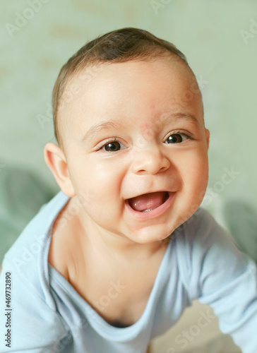 Close up portrait of happy and sweet little boy smiling.