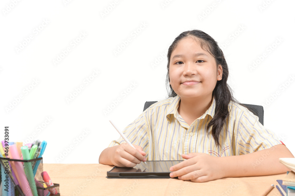 Happy girl student writes on digital tablet to study at home isolated on white background. Happy girl student writes on digital tablet to study at home isolated on white background.