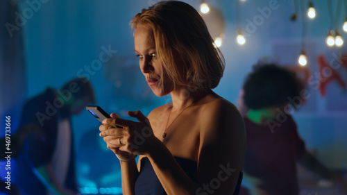 Woman flirting via text messages during party