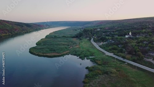 Flight over the river and small village in autumn. Moldova republic of. Molovata village. River Dniester. photo