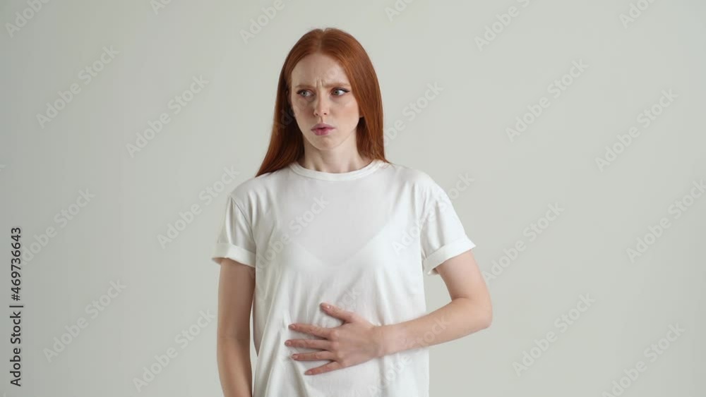 Portrait of sick young woman feeling painful cramp in stomach, grimacing and writhing in pain feeling stomach ache indigestion periods miscarriage running out of frame, on white isolated background. Portrait of sick young woman feeling painful cramp in stomach, grimacing and writhing in pain feeling stomach ache indigestion periods miscarriage running out of frame, on white isolated background.