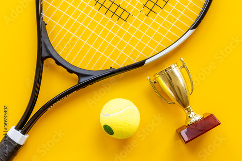 Tennis champion award - small golden trophy cup with tennis racket and ball © 9dreamstudio