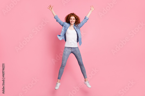 Full length photo of cheerful nice young woman jump up air smile active sportive isolated on pink color background