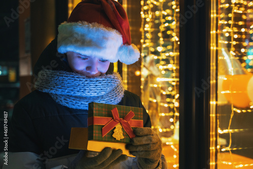 Boy in Santas hat with gift...