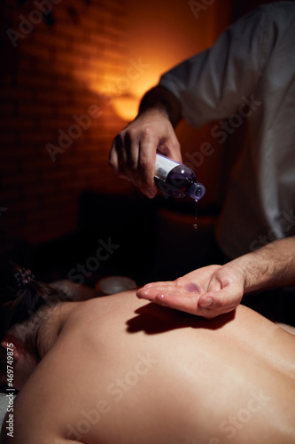 Woman on a massaging, chiropracting table, treatment of body and skin tension.