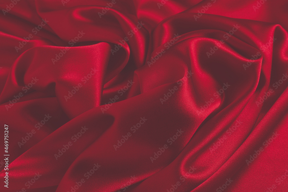 Obraz premium Red silk or satin luxury fabric texture can use as abstract background. Top view.