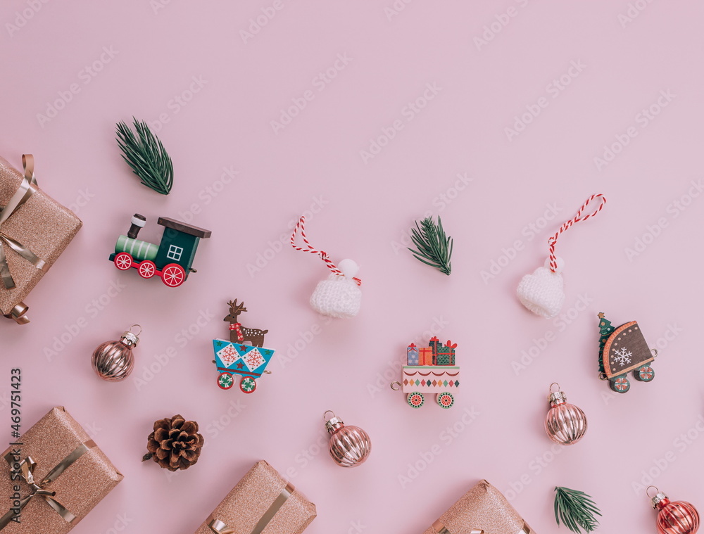 Christmas composition, fir tree branches, balls on pastel pink background. Winter, new year concept. Flat lay, top view, copy space