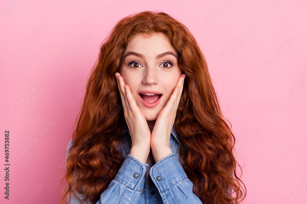 Photo of young girl happy positive smile amazed surprised hands touch cheeks news isolated over pink color background Photo of young girl happy positive smile amazed surprised hands touch cheeks news isolated over pink color background