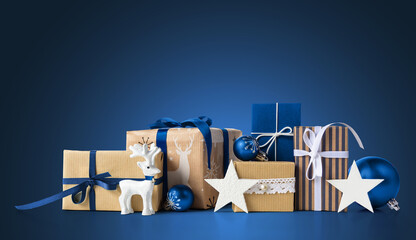 Gift boxes and christmas decorations on blue background