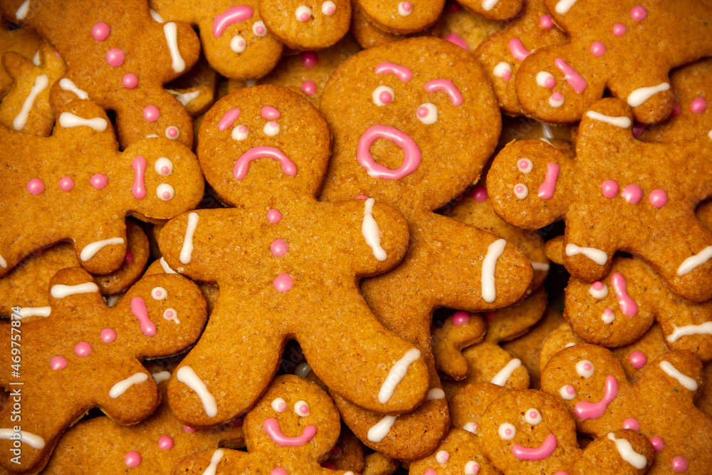 Homemade Christmas gingerbread men full of emotions lie on top of each other close up. Homemade Christmas gingerbread men full of emotions lie on top of each other close up.