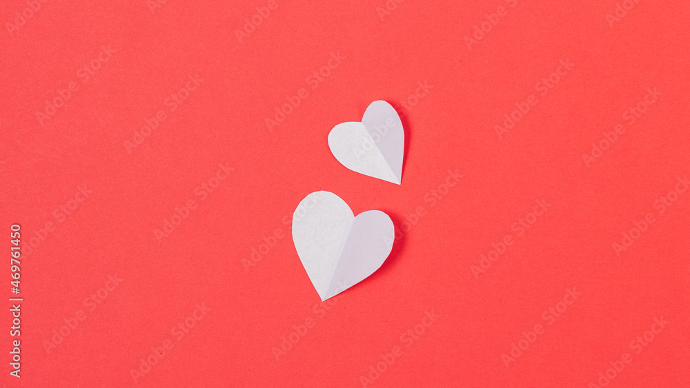 Paper hearts on red background
