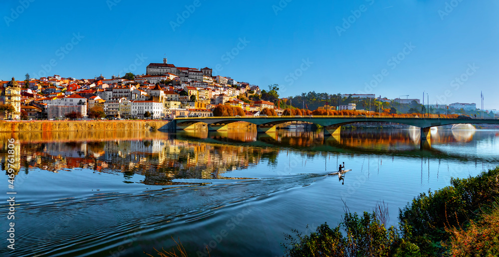 Canoeist doing sport at the end of the day on the River Mondego near the city of Coimbra, Portugal.