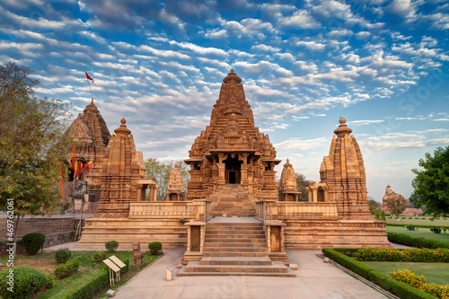 Beautiful image of Eastern Temples of Khajuraho, Madhyapradesh, India with blue sky and fluffy clouds in the background, It is worldwide famous ancient temples in India, UNESCO world heritage site. photo