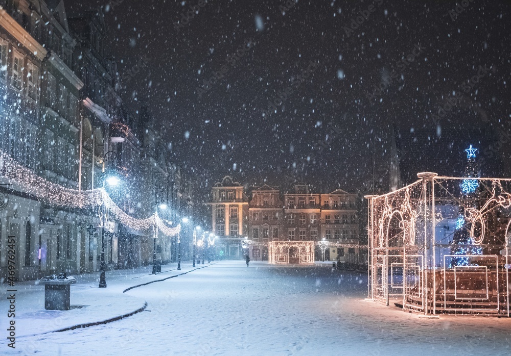 Late-night snowing at the Old Town square in Poznan, Poland