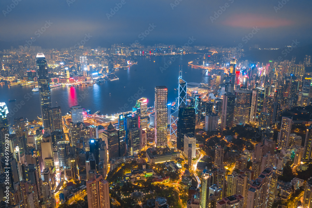 Aerial shot a Thousand of skyscraper on two side of Victoria Harbour of Hong Kong. View from the Peak at night.