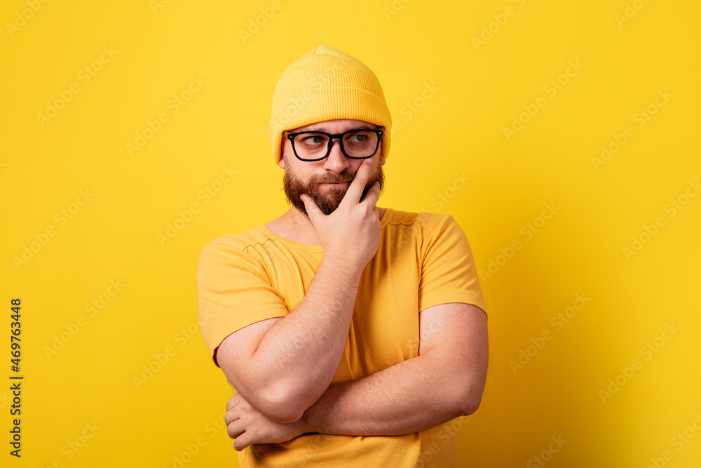 thinking man over yellow background, serious guy thinks