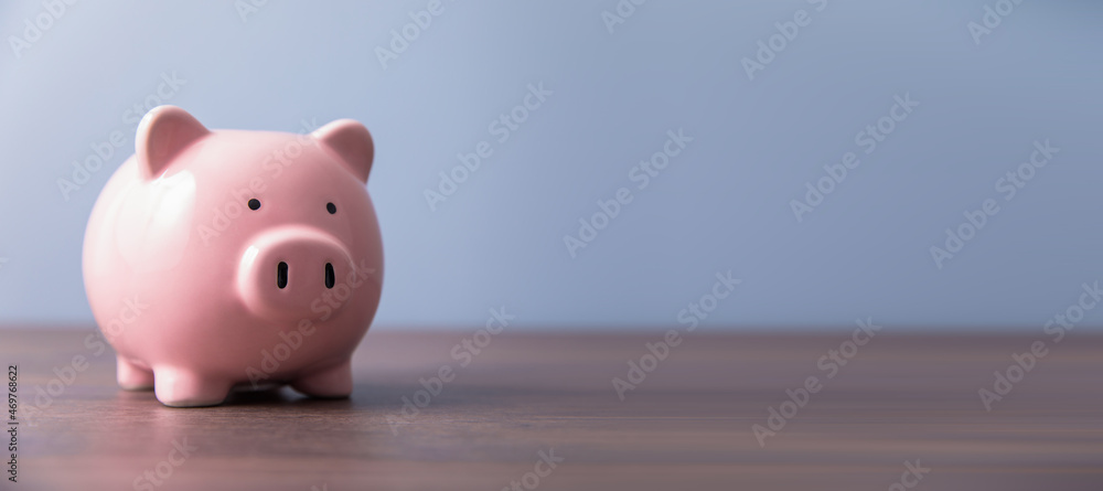 Fototapeta premium piggy bank on the wooden background