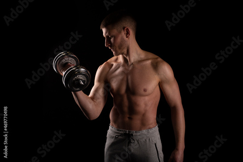 Man Pumping Biceps with Dumbbell Topless. Sprotsman Doing Traning on Biceps Muscles. Gym, Lifting Sport Concept.