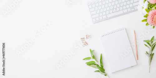 Wallpaper Mural Flat lay home office desktop with notebook, flowers in a vase, office supplies on a light background Torontodigital.ca