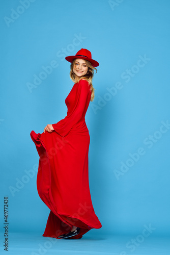 woman in red dress multicolored umbrella blue background