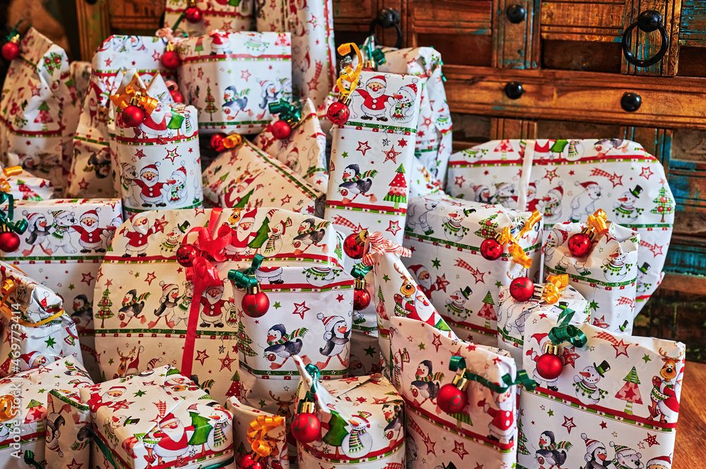 Wrapped gifts in front of an old wooden table that are part of an advent calendar.
