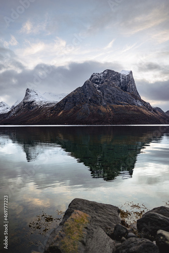 Nordic Bergsbotn Fjord in Senja, Norway with rocky mountains reflecting in the calm water
