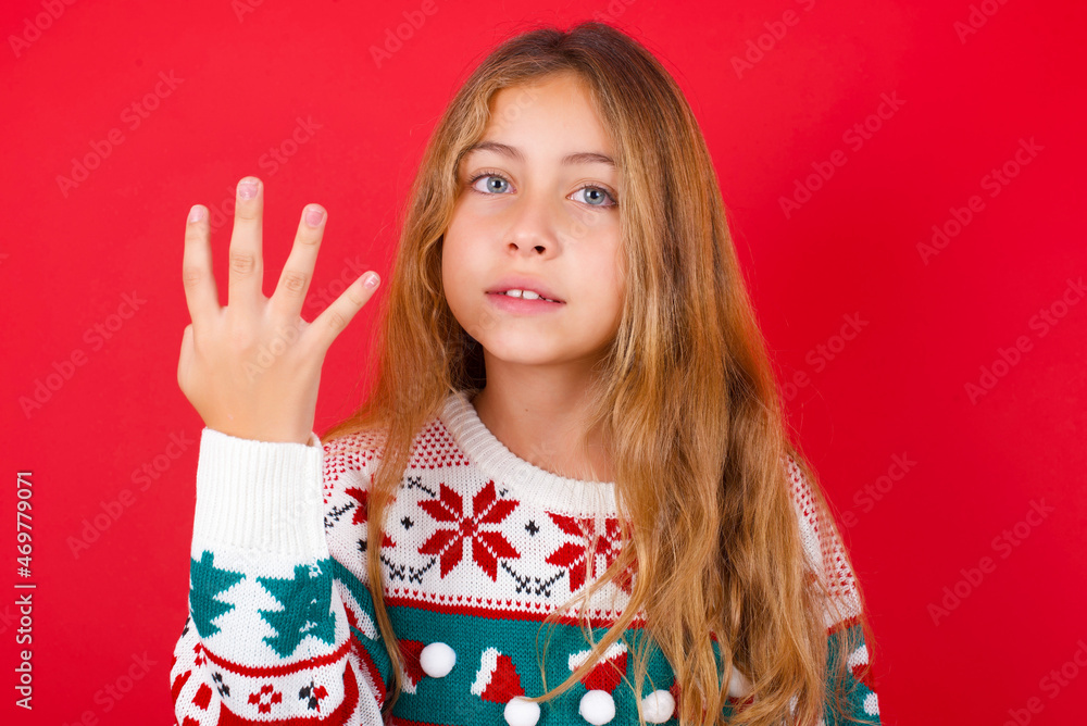 little kid girl wearing knitted sweater christmas over red background smiling and looking friendly, showing number four or fourth with hand forward, counting down little kid girl wearing knitted sweater christmas over red background smiling and looking friendly, showing number four or fourth with hand forward, counting down