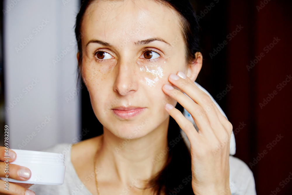 Young caucasian woman uses a transparent patches with sparkles. Dermatology multiuse cosmetics, multitasking beauty. Scinimalism concept, polytasking functions. Macro, close up face photography. Young caucasian woman uses a transparent patches with sparkles. Dermatology multiuse cosmetics, multitasking beauty. Scinimalism concept, polytasking functions. Macro, close up face photography.