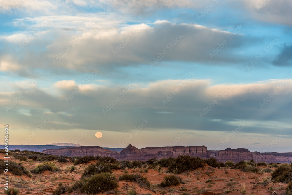 Full moon in the morning over Monument Valley