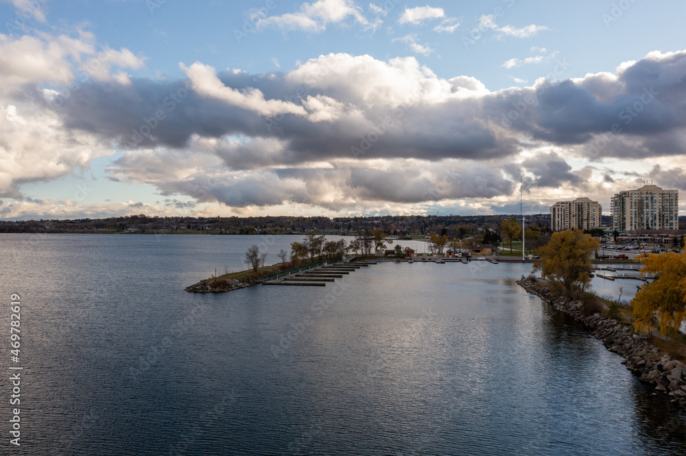 Lake Simco Barrie drone views of centennial park boatyard  around sunset with over class clouds 