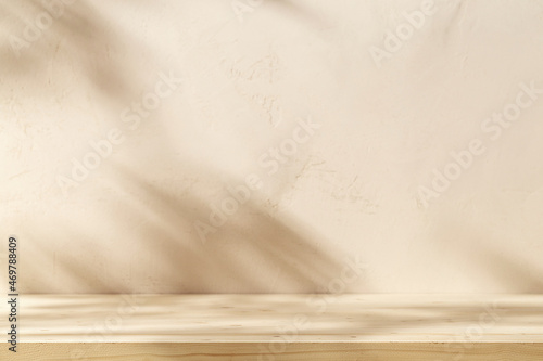 Wooden table mockup on stucco background with branch shadows on the wall. Mock up for branding products, presentation and health care.	
 photo