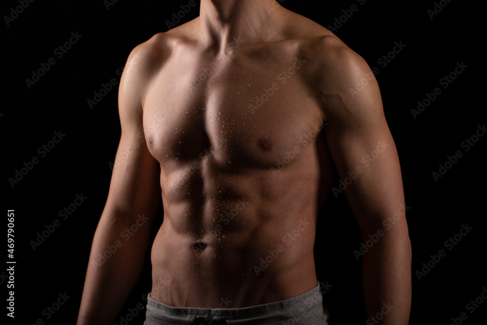 Man Showing ABS. Muscle man Posing. Strong Body Concept. Topless Sportman Bodybuilder. Six Pack