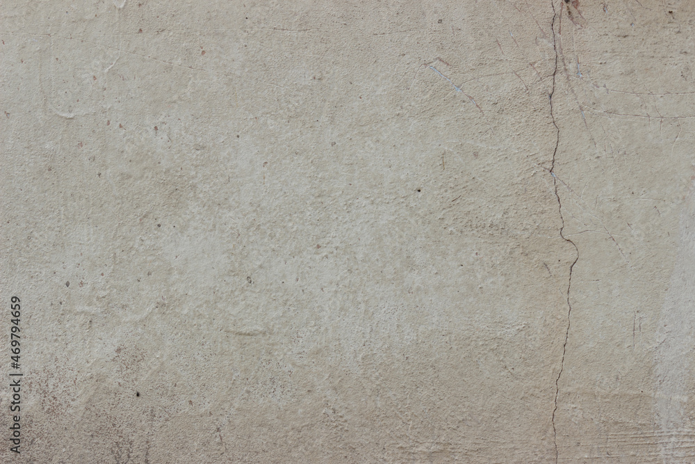 Beige concrete wall texture with interested crack in corner Beige concrete wall texture with interested crack in corner