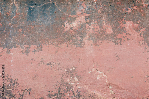 Old crumbled brown concrete wall with spots and cracks 