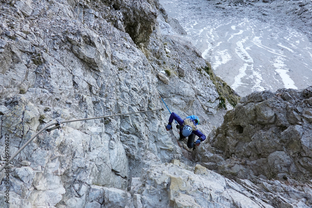 Woman on via ferrata of Monte Paterno. Adventure activity in Dolomites, Italy 