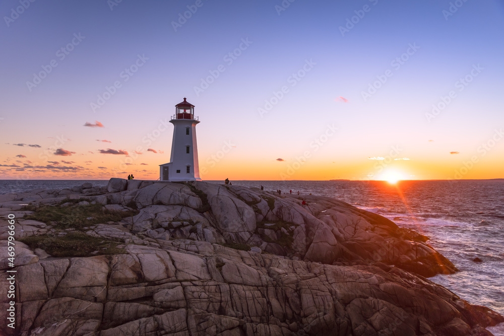 A dramatic sunset at Peggy's Cove Lighthouse Atlantic Coast Nova Scotia Canada. The most visited tourist location in the Atlantic Canada