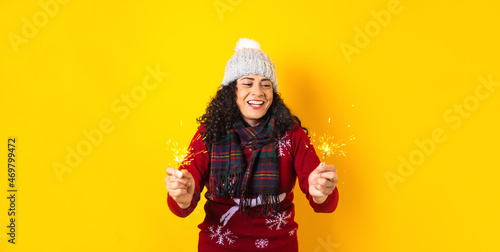 young latin woman having fun with sparklers for Christmas party in Mexico latin america 